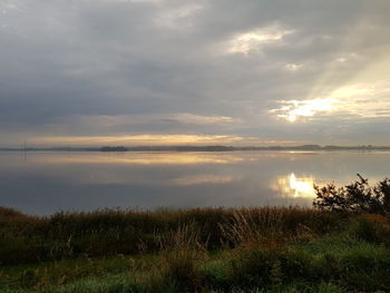 Scenic view of lake against sky during sunset