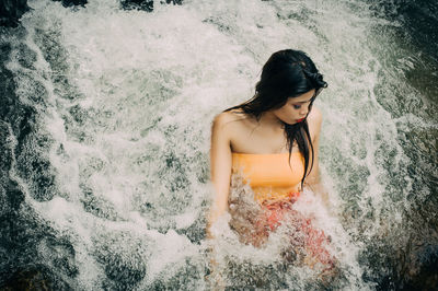 High angle view of young woman in water