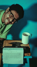 Portrait of smiling man holding eyeglasses