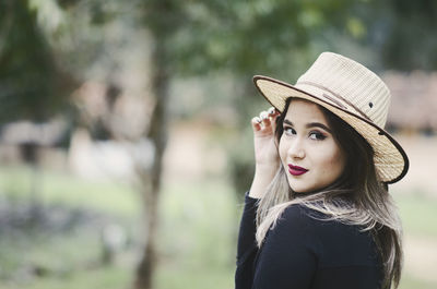 Portrait of beautiful young woman wearing hat