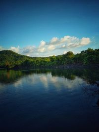 Scenic view of lake against blue sky