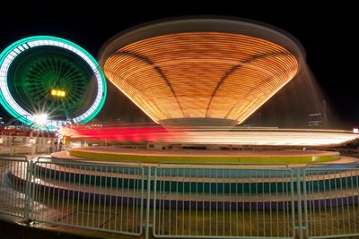 Illuminated ferris wheel at night