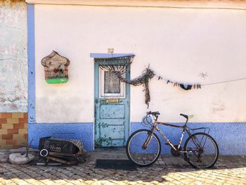 Bicycle parked on wall of old building