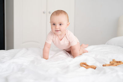 Cute baby playing on bed