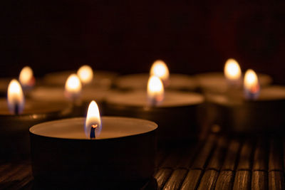 Close-up of illuminated tea light candles on table