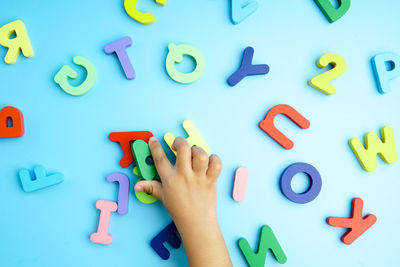 Cropped hand of woman with toy blocks