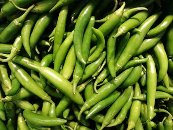 Full frame shot of green chili peppers for sale at market