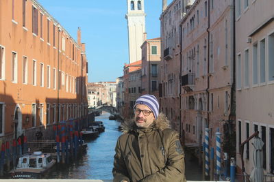 Rear view of man standing in city