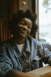 Portrait of young man sitting at home