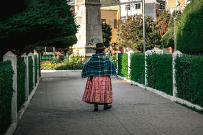 Rear view of woman on footpath