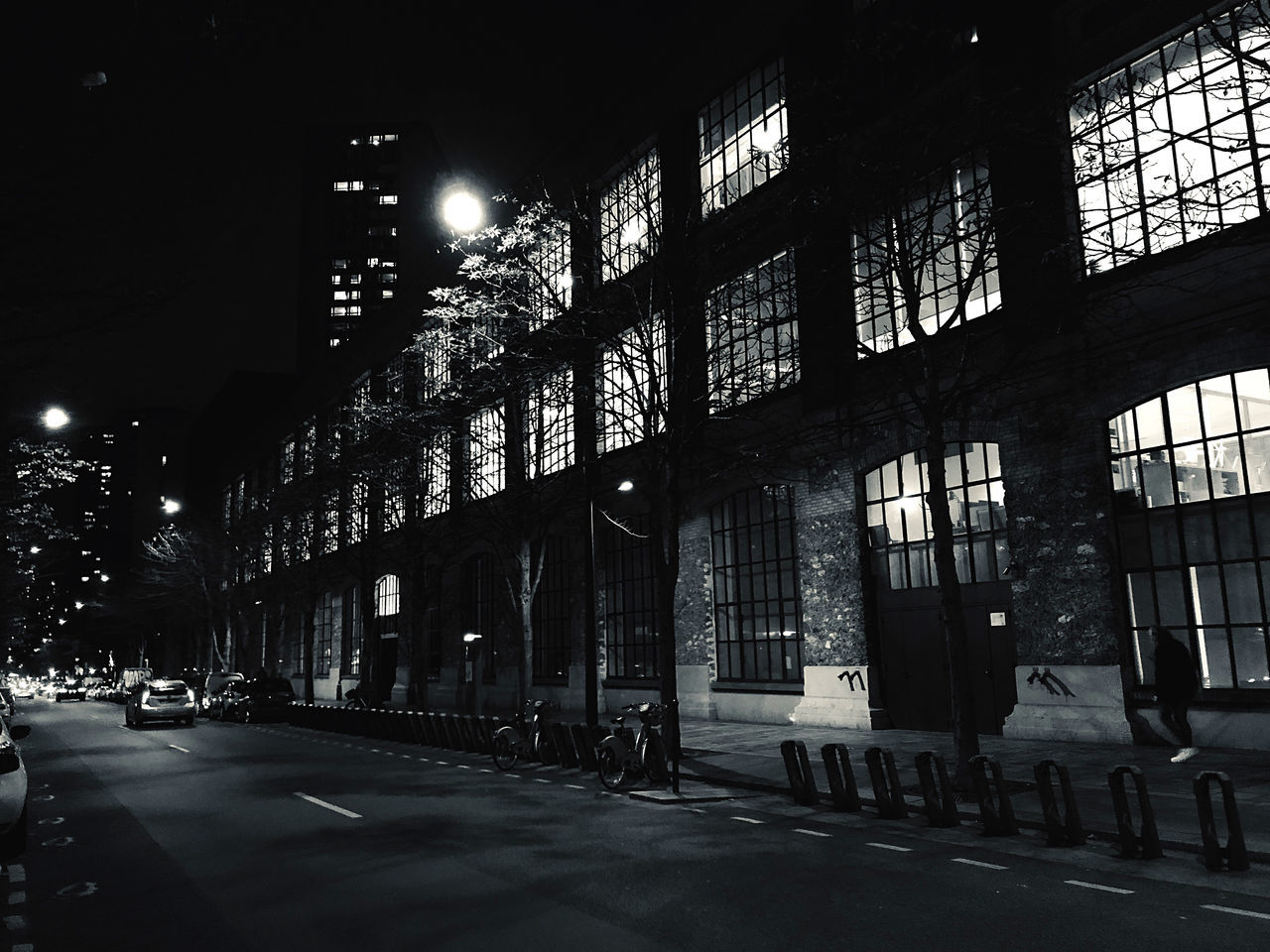 architecture, built structure, building exterior, night, city, transportation, building, street, illuminated, motor vehicle, car, land vehicle, mode of transportation, road, incidental people, street light, residential district, lighting equipment, outdoors