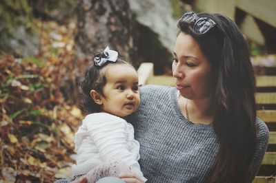 Mother holding baby outdoors