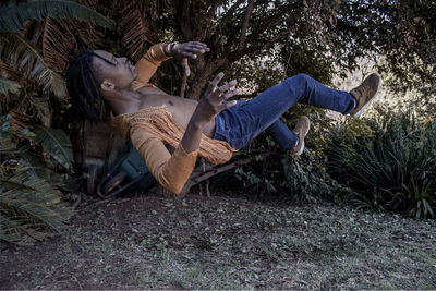 Young woman lying down in forest