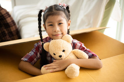 Cute baby girl in toy at home