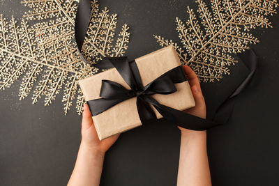 Midsection of woman holding paper in box