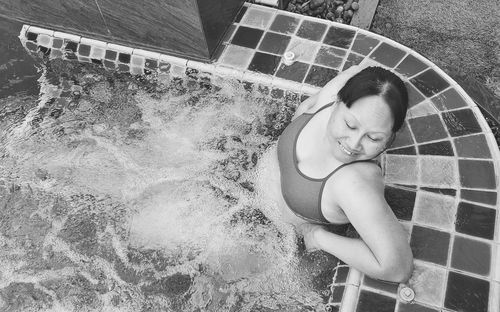 Portrait of young woman swimming in pool