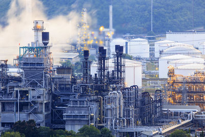 Factory against cloudy sky