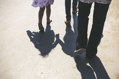 Low section of family walking on walkway