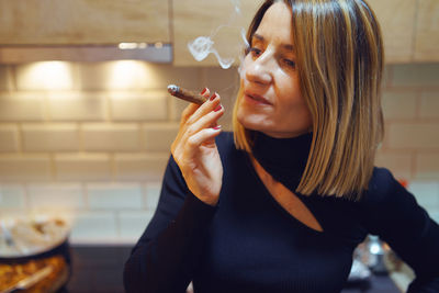 Portrait of woman smoking cigarette