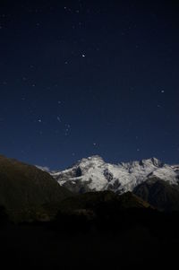 Scenic view of mountains against sky at night