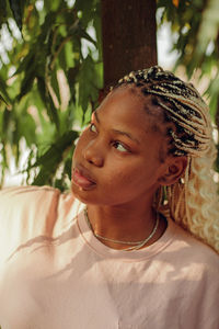 Close-up portrait of a young woman looking away