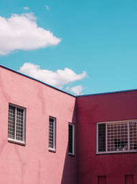 Low angle view of residential building against blue sky