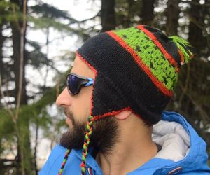 Side view of handsome bearded man wearing knit hat during winter