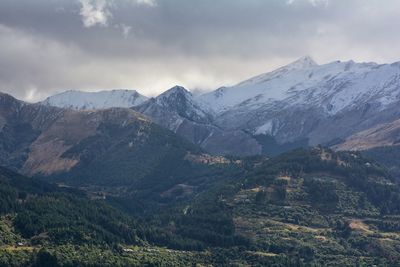 Scenic view of mountains against cloudy sky