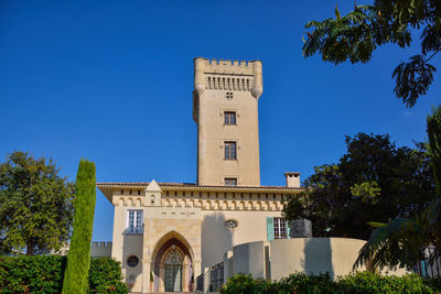 Low angle view of historical building against clear blue sky