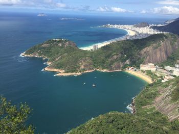 Aerial view of sea and mountains against sky