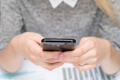 Midsection of man using mobile phone