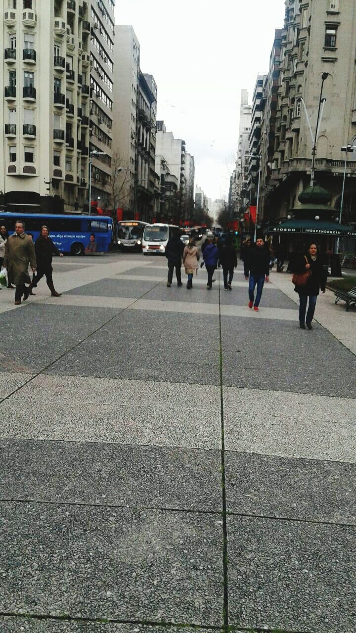 PEOPLE WALKING ON ROAD IN CITY