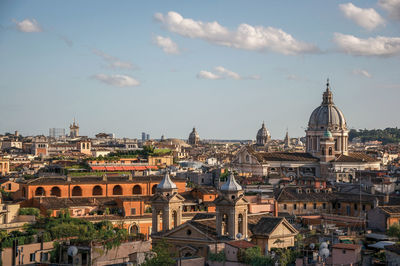 Overview cathedrals domes and roofs of buildings in the sunset of rome, italy.
