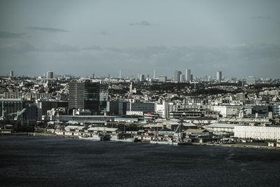 High angle view of buildings in city against sky