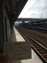 Train at railroad station against sky