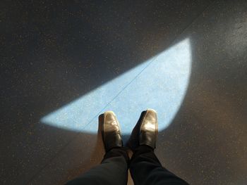 Low section of man standing on floor