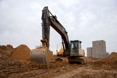 Old construction site on field against sky