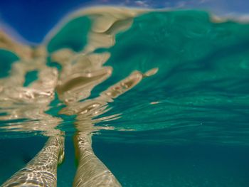 Low section of person swimming in sea