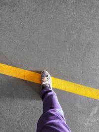 Low section of person standing on road