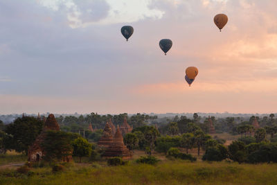 Hot air balloons flying over landscape