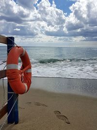 Man at beach against sky