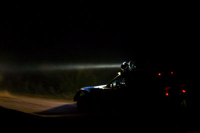 Man working against sky at night