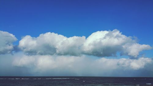 Scenic view of sea against blue sky