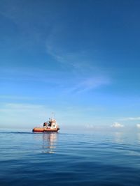 Ship in sea against blue sky