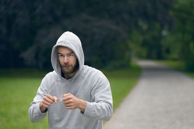 View of young man working out in a park, shadow boxing