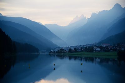 Scenic view of lake and mountains against sky