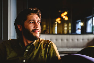 Man looking away while sitting on seat