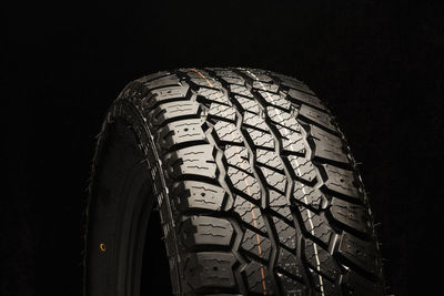 Close-up of tire against black background