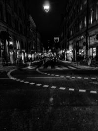 Cars on road in city at night