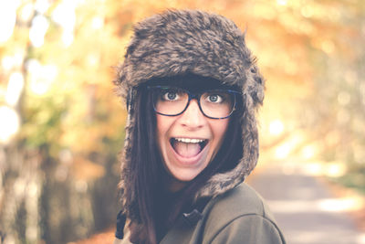 Close-up portrait of young woman screaming while standing at park